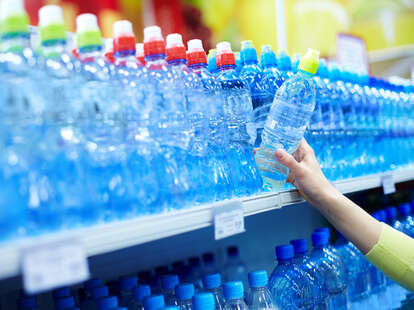 woman buying plastic water bottles