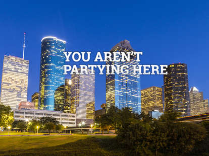 Houston Texas modern skyline at sunset twilight from park lawn