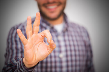 man making okay sign with fingers