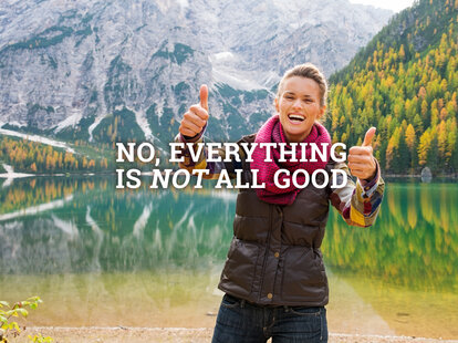 tourist holding two thumbs up