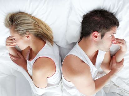 annoyed couple in bed together
