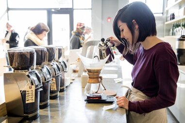 girl pouring coffee