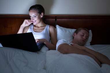 woman on the internet at night husband sleeping