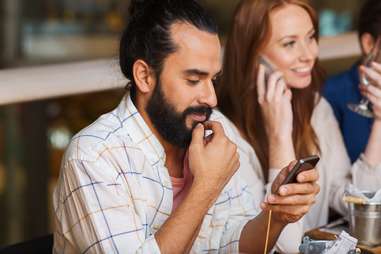 man on the phone with friends