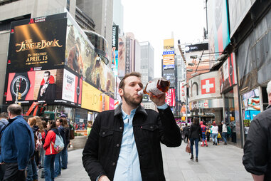 Man drinking in Times Square