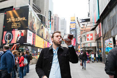 Man drinking in Times Square