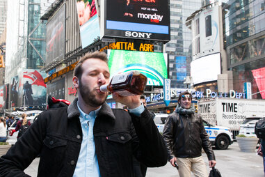 Man drinking whiskey in Times Square
