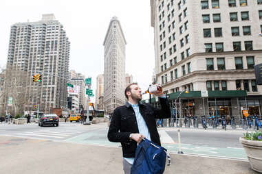 Man drinking in front of Flatiron Building