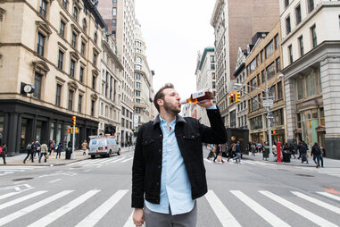 Man drinking in the middle of Fifth Avenue