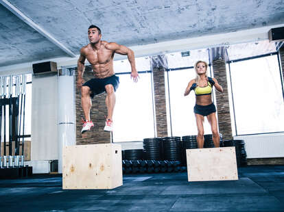man and woman jumping on a fit box