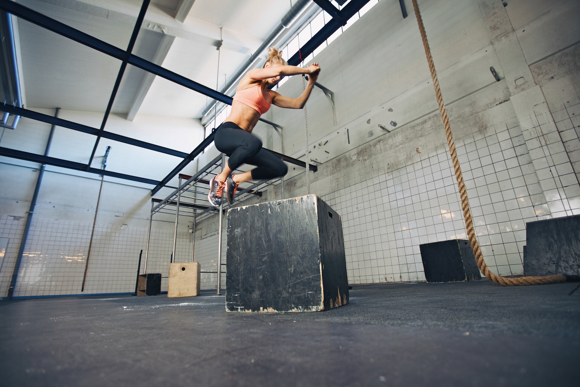 jumping at crossfit, woman jumping on a fit box