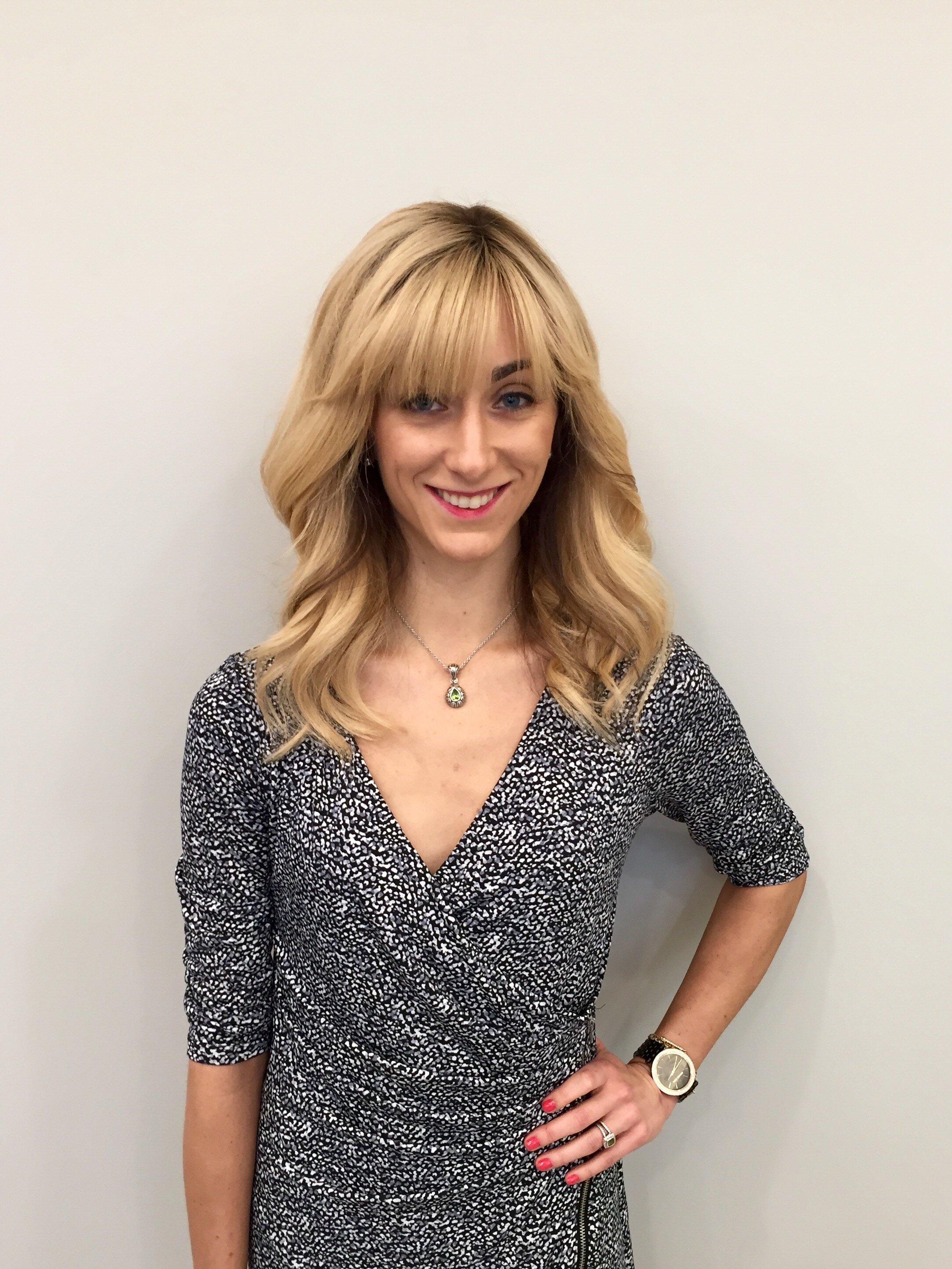 blonde woman in front of a wall
