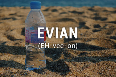 Bottle evian on sand