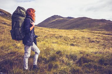 woman hiking outside alone travel