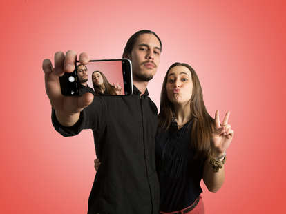 couple taking a selfie why you shouldn’t post relationship on social media