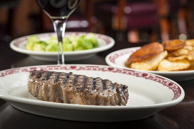 Gene and Georgetti’s Restaurant, steak with wine and salad