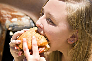 woman eating big burger