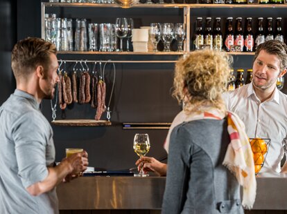 bartender and couple at a bar