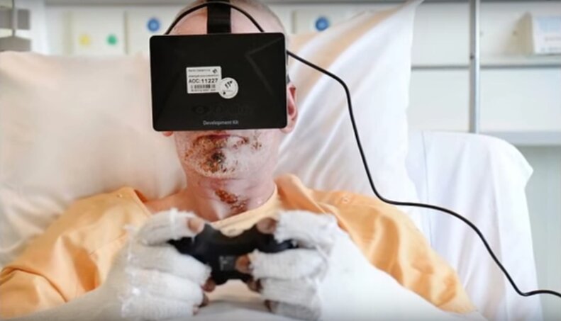 man in hospital bed wearing virtual reality headgear