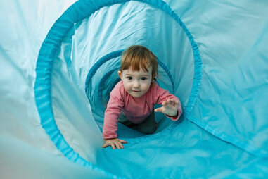 toddler in play area crawling