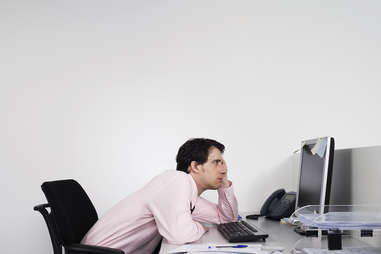 Business man slouched in front of computer