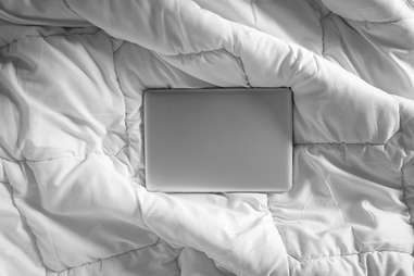 Closed laptop on bed