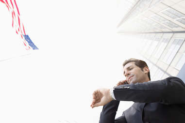 businessman on phone looking at watch