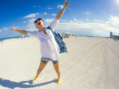 happy woman on beach in miami