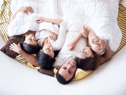 Man in bed with three women 
