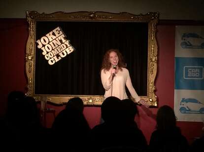 joke joint comedy club girl on stage 
