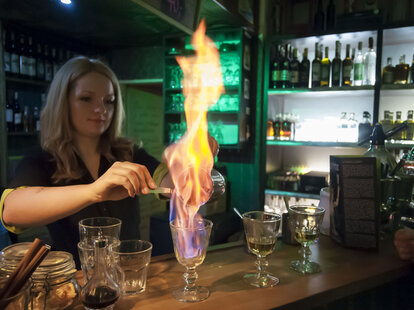 Woman preparing absinthe