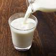 Milk poured into glass milks whole skim fat percent