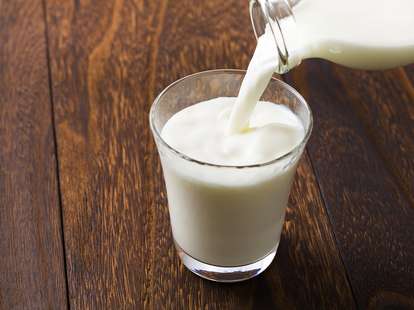 Milk poured into glass milks whole skim fat percent