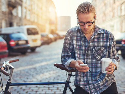 man on his phone being pensive