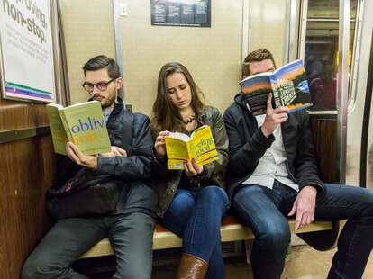 people reading on the subway