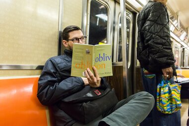 guy reading david foster wallace on subway