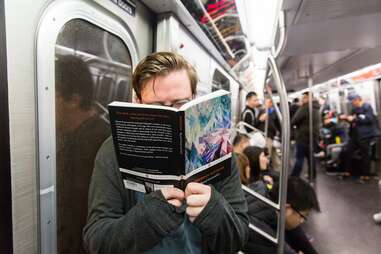 Guy reading Nietzsche on subway