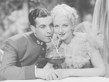 Vintage photo of couple on dating sharing drink