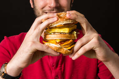 man eating big hamburger