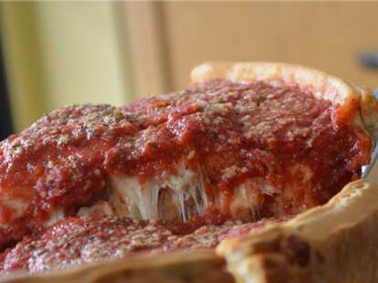 The Art of Pizza Chicago deep dish slice with a lot of sauce thrillist