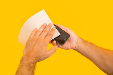 Using paper towel to clean an iPhone