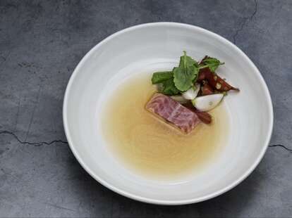 lyle's london thrillist a piece of meat with a leaf on white plate