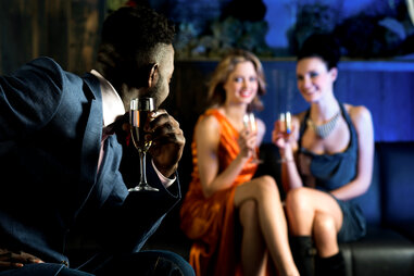 man and two woman and a club drinking