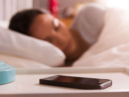 woman sleeping next to phone