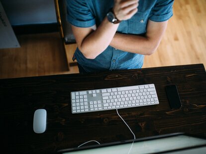 man standing at computer