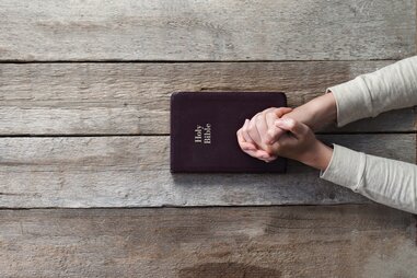 Woman praying over bible