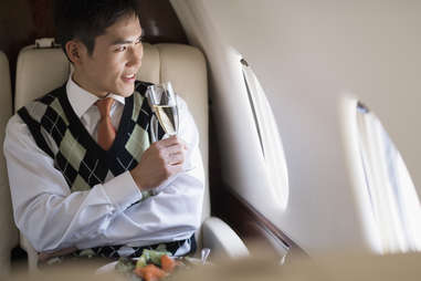 well-dress business man first class airplane