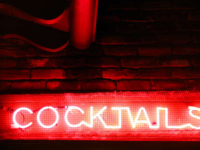 A red neon sign advertising cocktails. 