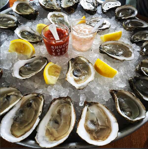 Couple shucking oysters