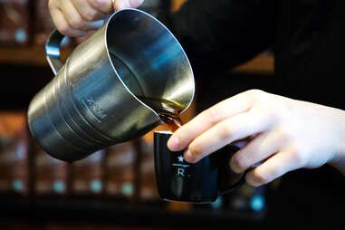 barista pouring coffee